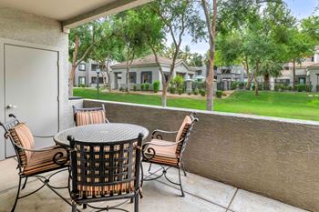 Covered patio overlooking courtyard with outdoor furniture